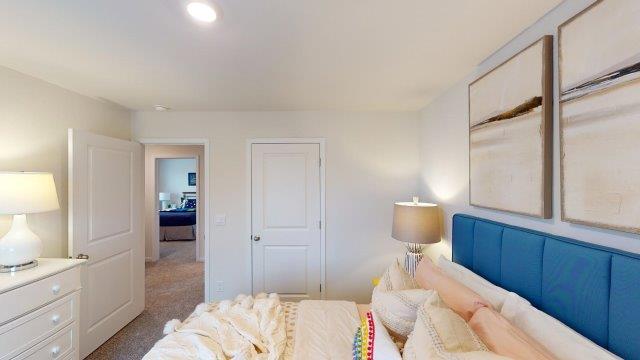 Bedroom featuring a bed, decorated in dark blue tones with a large window