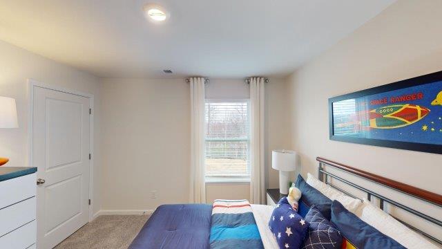 Bedroom featuring a bed, decorated in dark blue tones with a large window