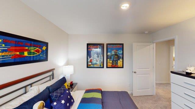 Bedroom featuring a bed, decorated in dark blue tones with a large window