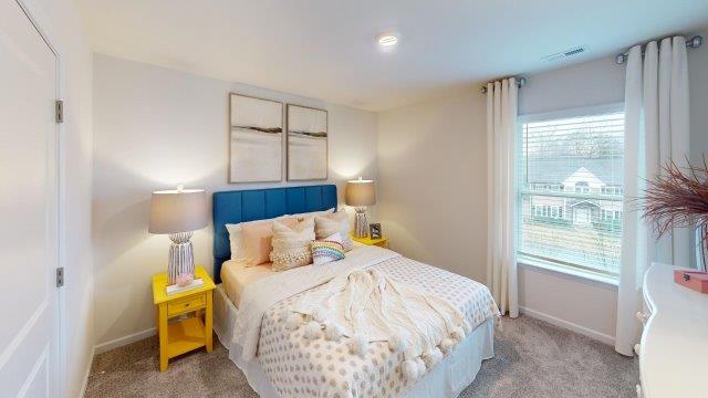 Bedroom featuring a bed, decorated in dark blue tones with a large window