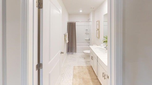 Bathroom with white cabinets and counters