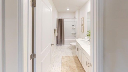 Falls at Hickory Robie Model bathroom with white counters and cabinets, standing shower