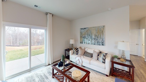 Living room featuring a white sofa, decorated in blue tones with a modern black fireplace