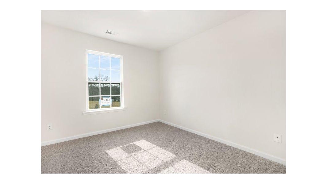Carpeted bedroom with small window