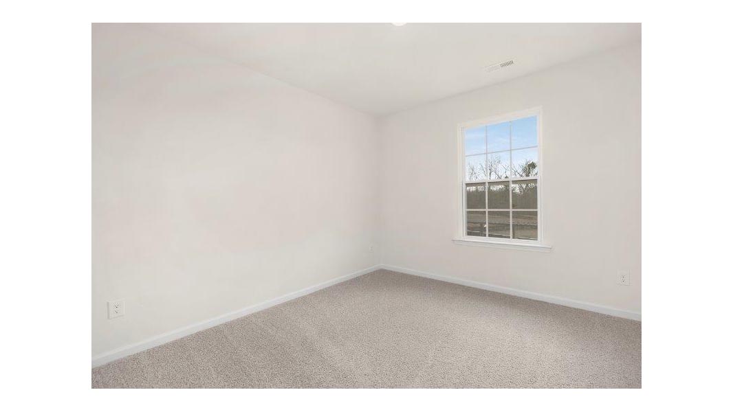Carpeted bedroom with small window