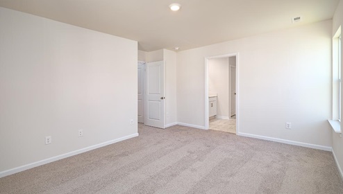 Carpeted bedroom view of entryway