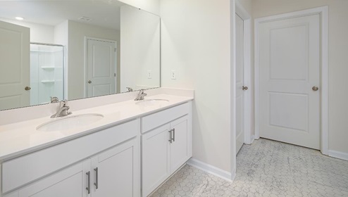 Bathroom with white counters and cabinets