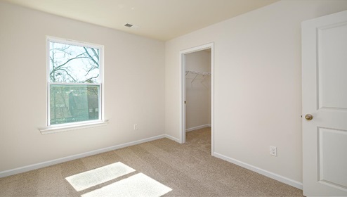 Carpeted bedroom with large window