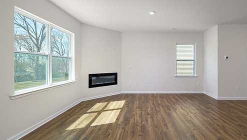 Living room area, with two large windows and wooded floors