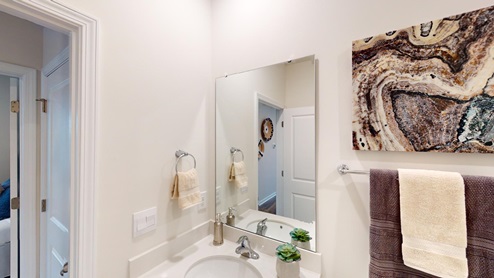 Bathroom featuring a vanity sink, and mirror above