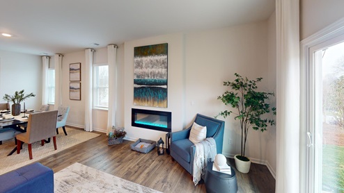 Living room featuring a white sofa, decorated in blue tones with a modern black fireplace