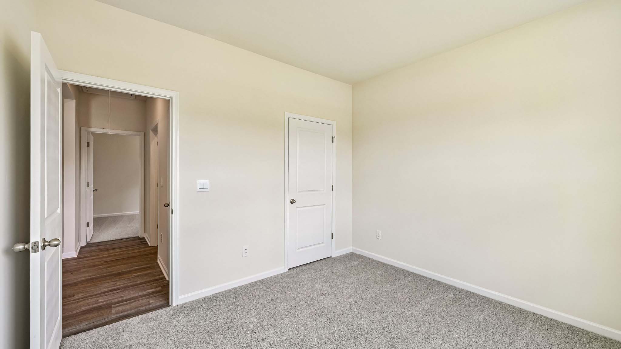 Carpeted bedroom with large window