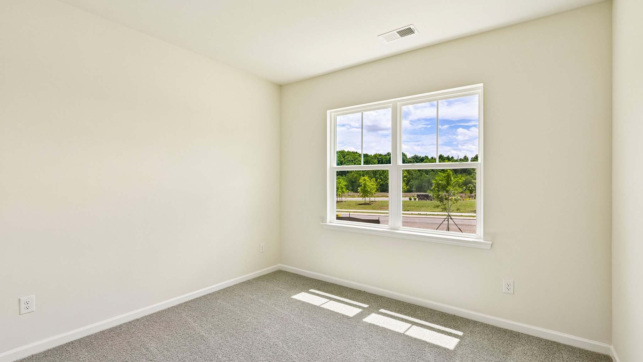Carpeted bedroom with large window