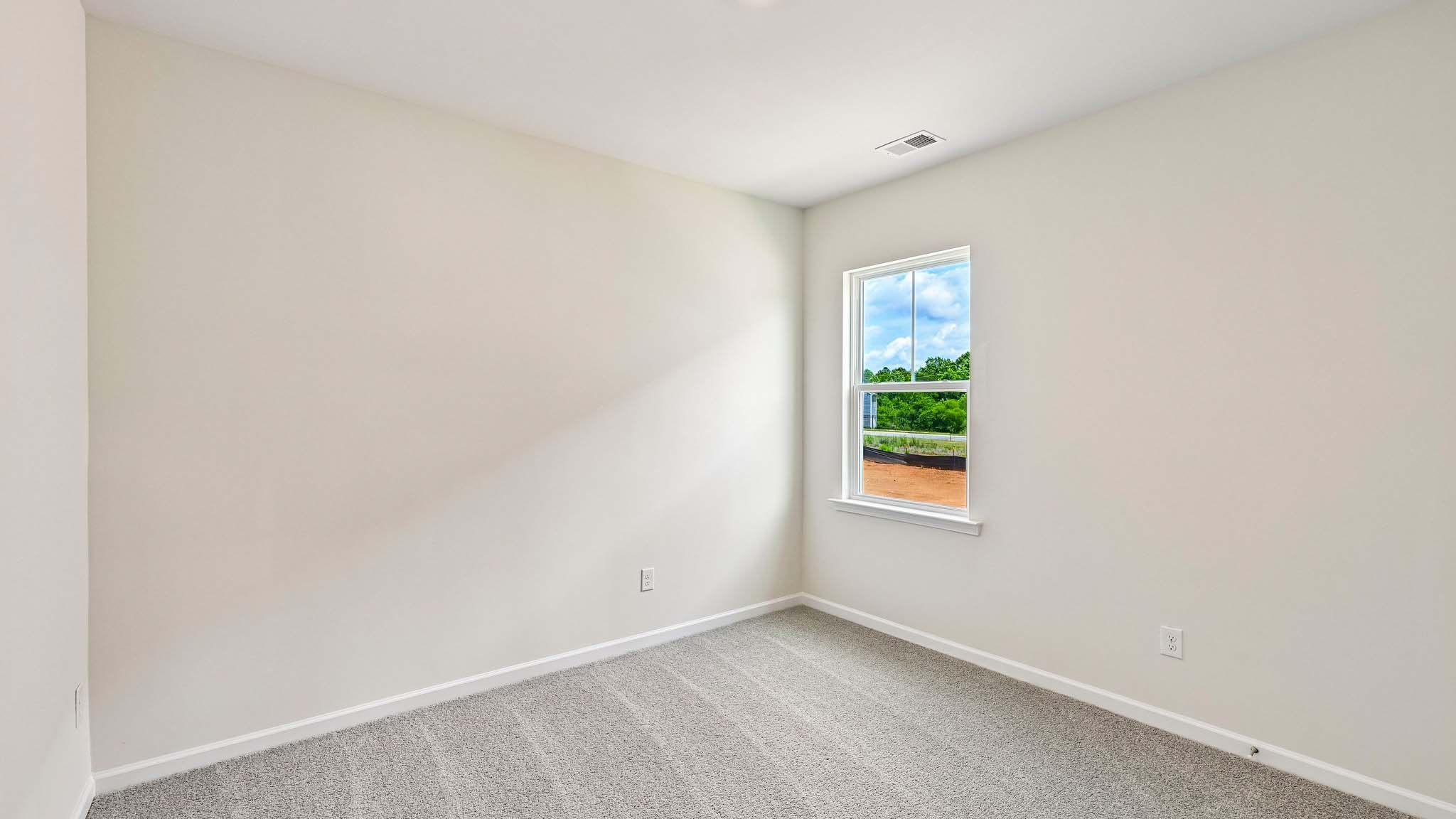 Carpeted bedroom with large window