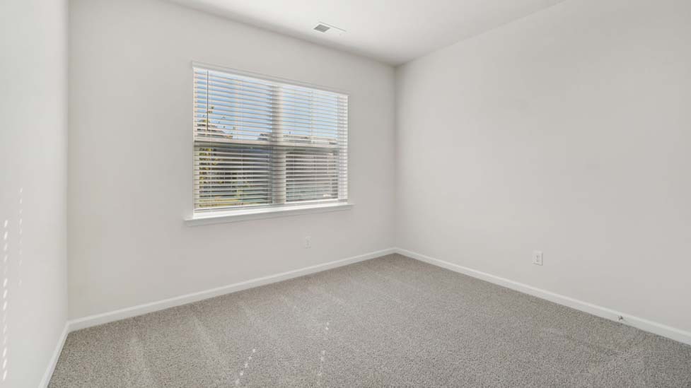 Carpeted bedroom with large window