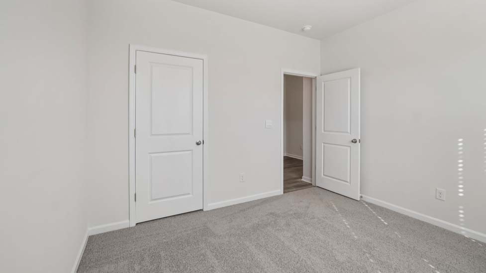 Carpeted bedroom with large window