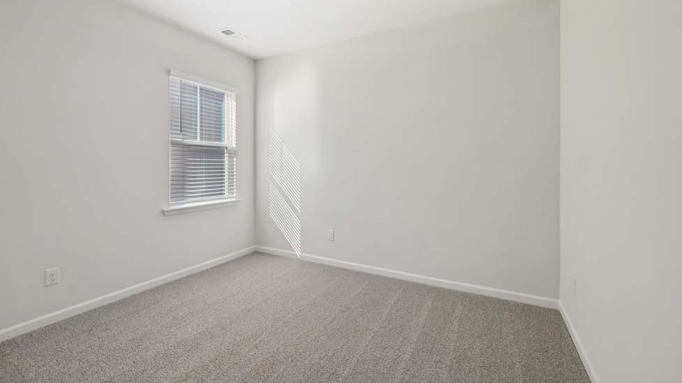 Carpeted bedroom with large window