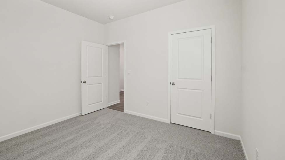 Carpeted bedroom with large window