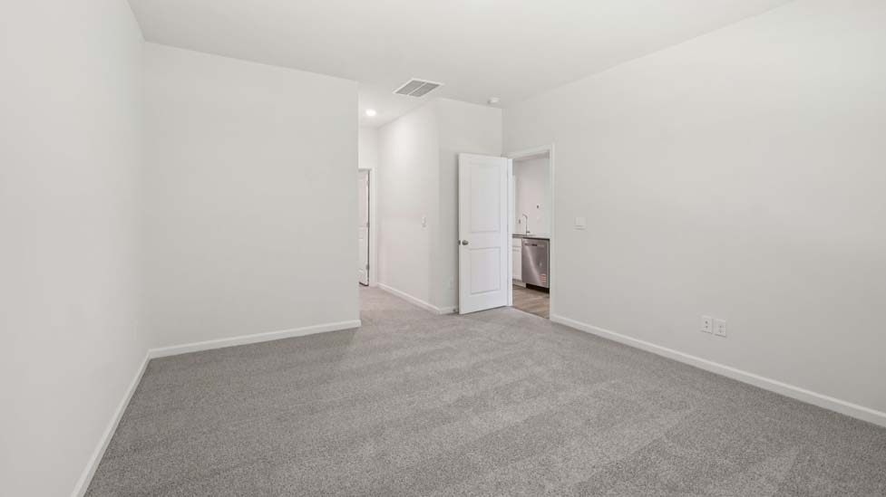 Carpeted bedroom with large window