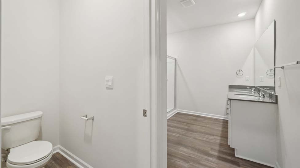 Bathroom with white cabinets and counter, and bathtub