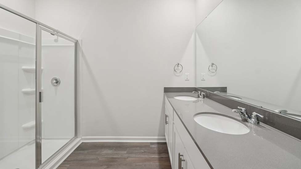 Bathroom with white cabinets and counter, and bathtub