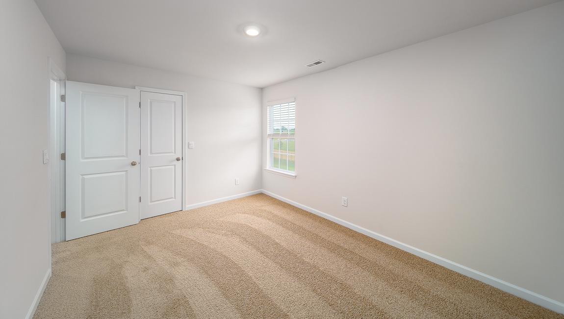 Carpeted bedroom with large window