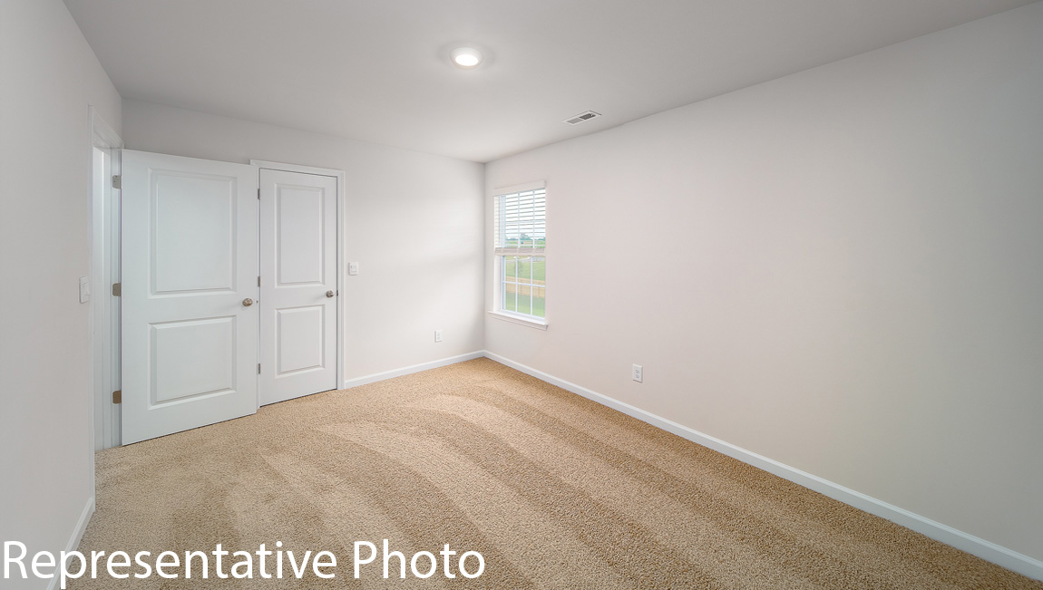 Carpeted bedroom with large window