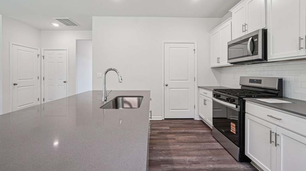Kitchen and island with stainless steel appliances