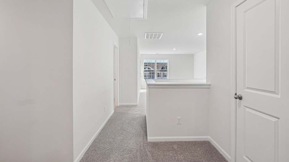 Upstairs carpeted loft with large window