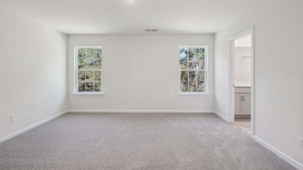 Carpeted bedroom with large windows