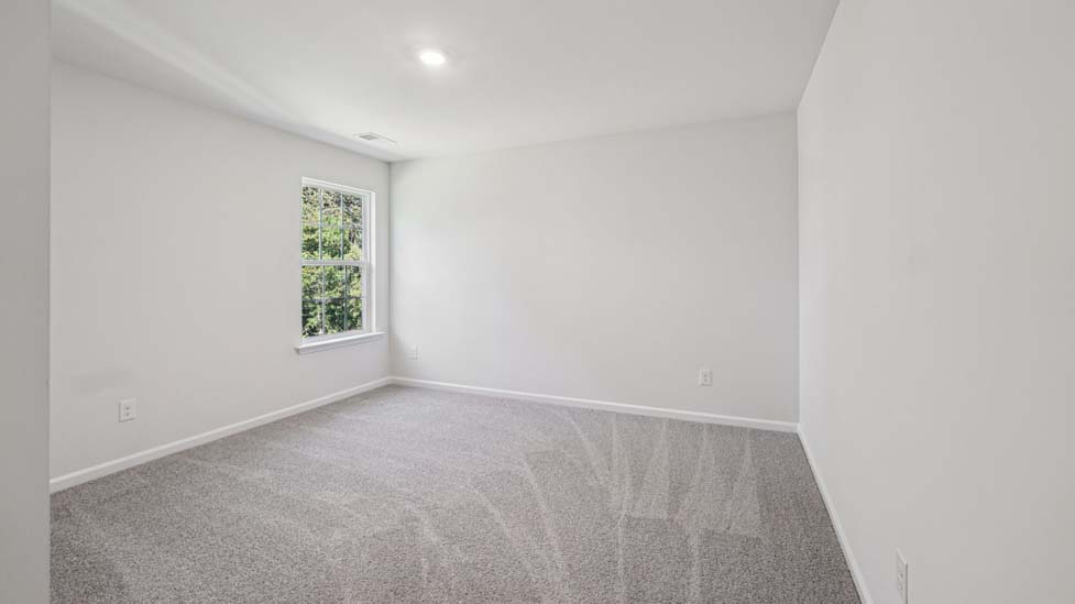 Carpeted bedroom with large windows