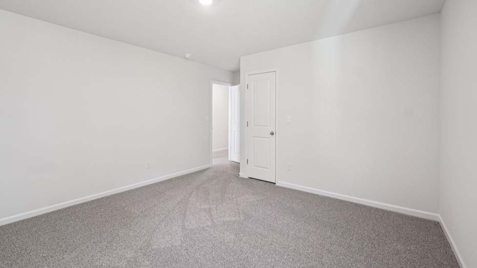 Carpeted bedroom with large windows