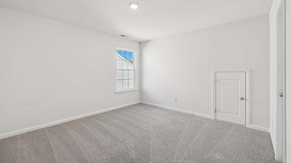 Carpeted bedroom with large windows