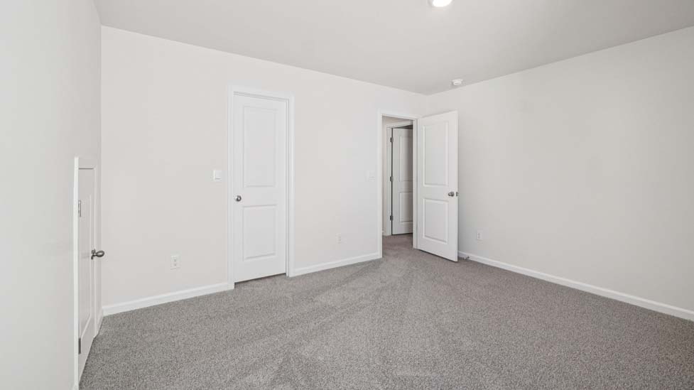 Carpeted bedroom with large windows