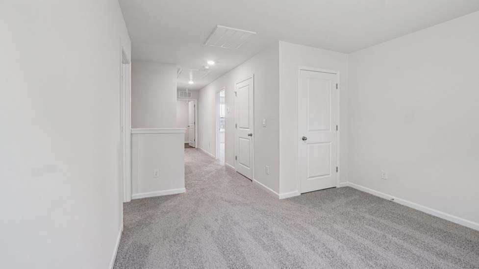 Carpeted bedroom with large windows