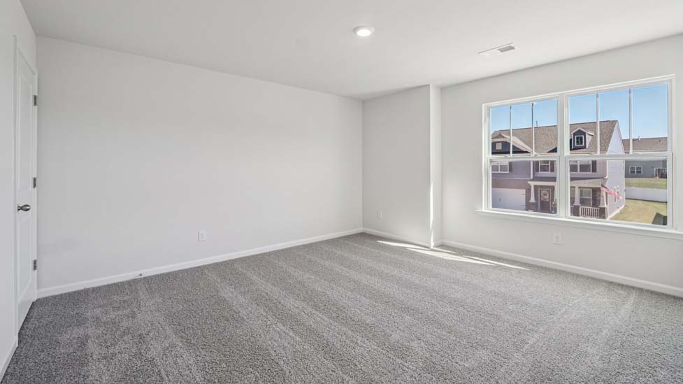 Carpeted bedroom with large windows