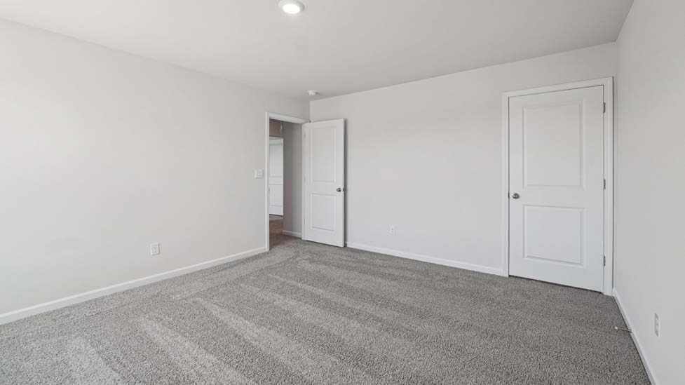 Carpeted bedroom with large windows