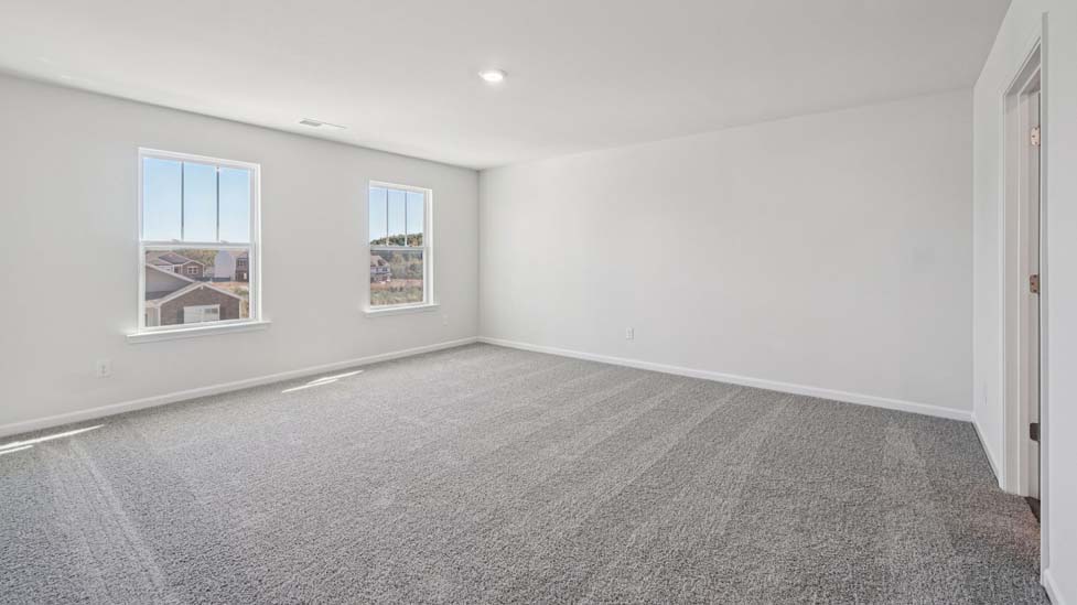 Carpeted bedroom with large windows