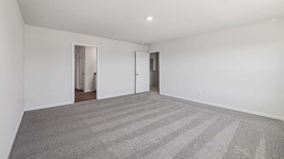 Carpeted bedroom with large windows