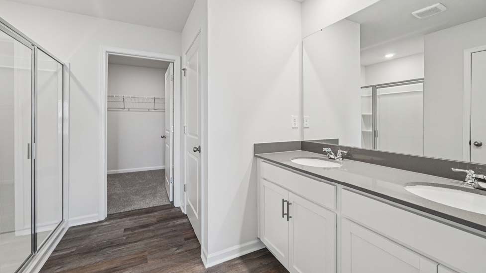 Primary bethroom with double sink vanity and large shower