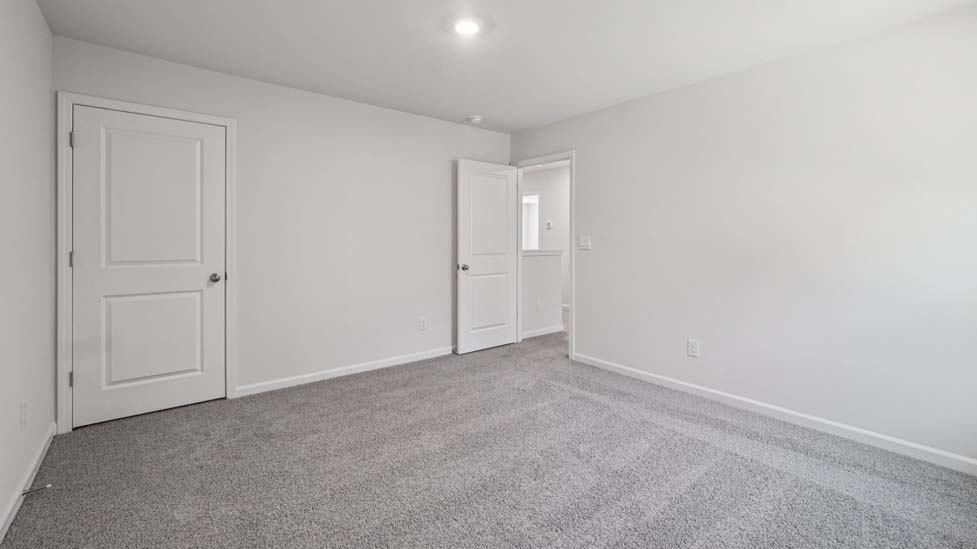 Carpeted bedroom with large windows
