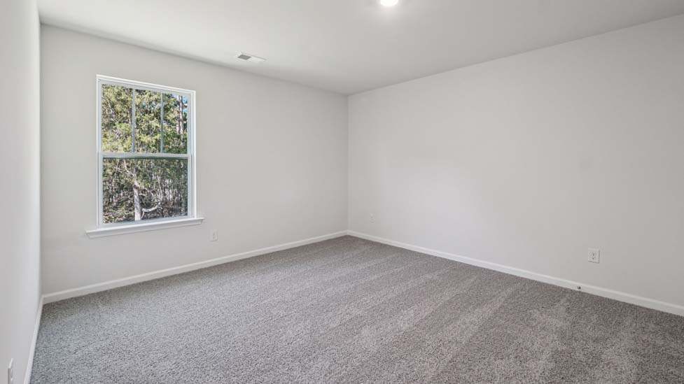 Carpeted bedroom with large windows