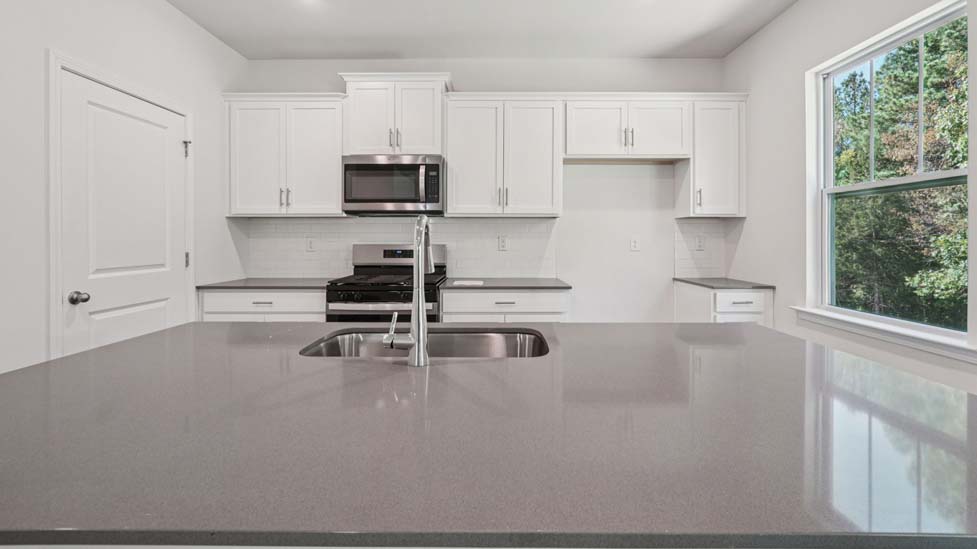 Kitchen and island with stainless steel appliances