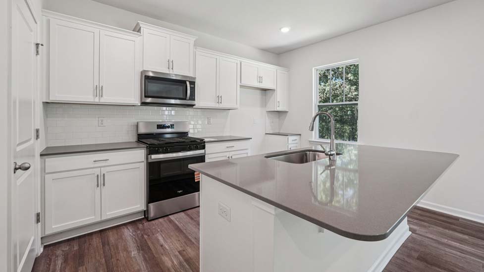 Kitchen and island with stainless steel appliances
