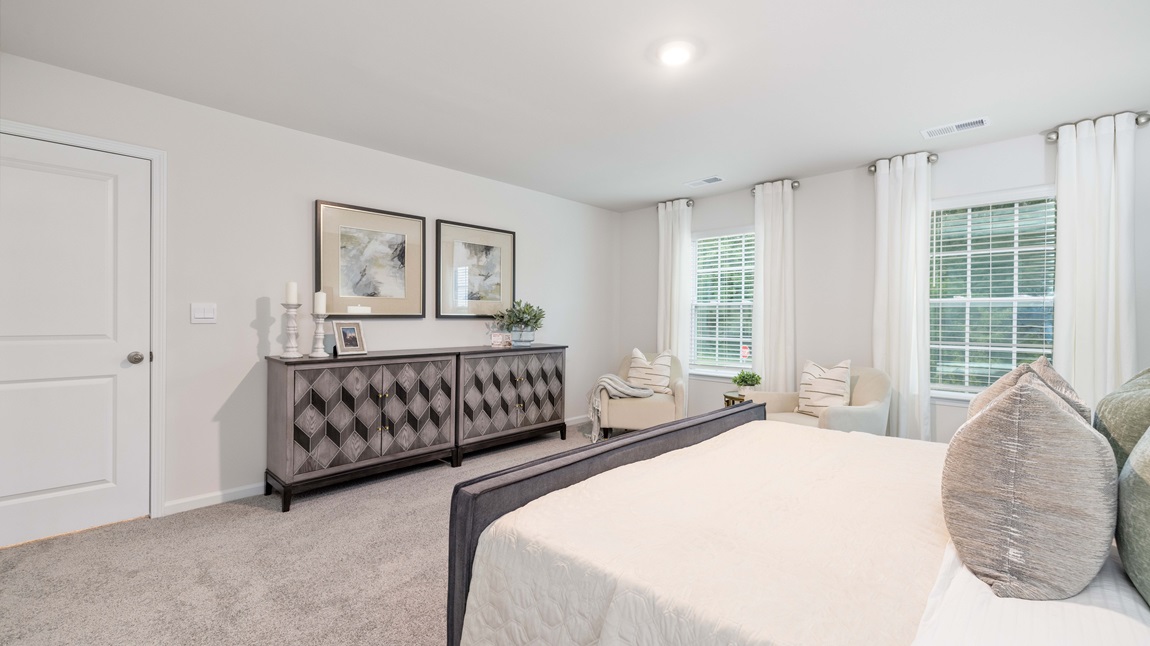 Carpeted bedroom with large windows