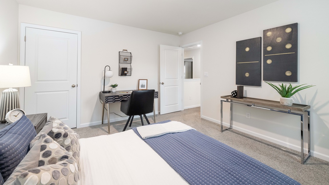 Carpeted bedroom with large windows