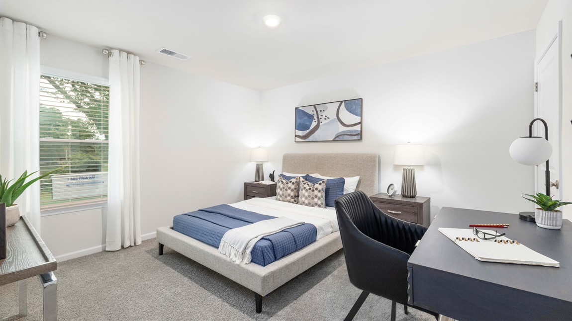 Carpeted bedroom with large windows
