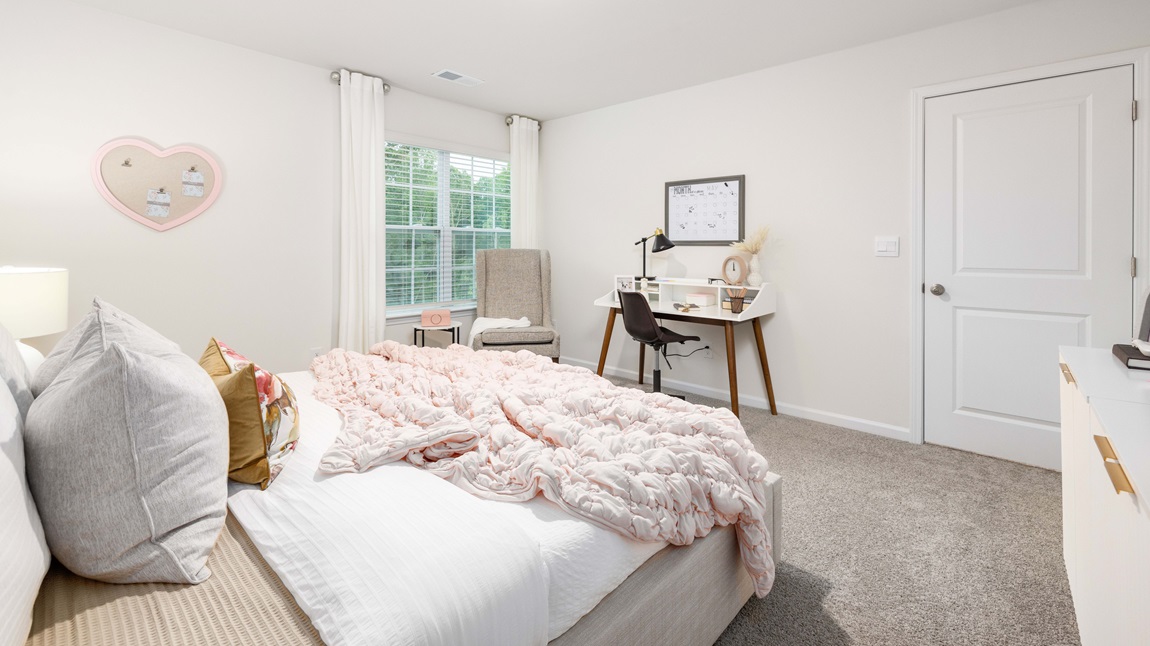 Carpeted bedroom with large windows