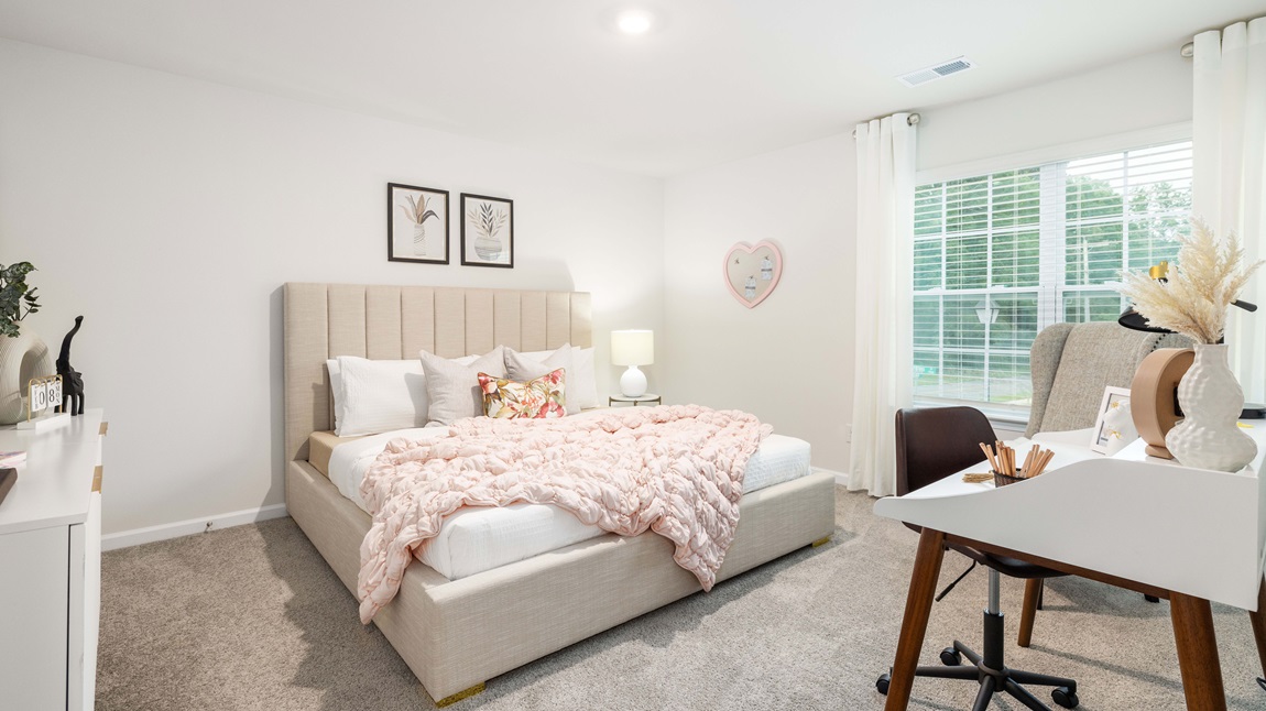 Carpeted bedroom with large windows
