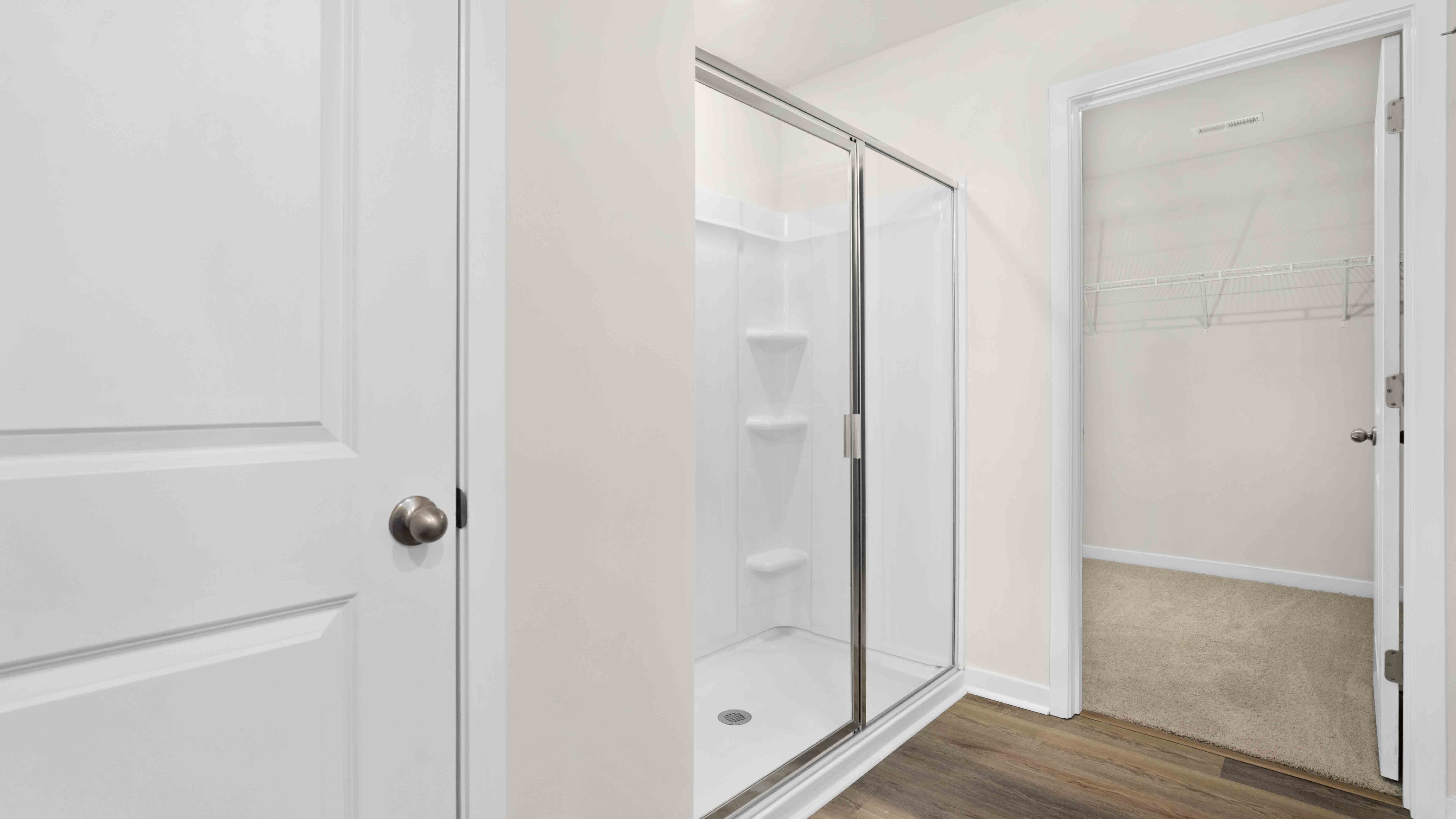 primary bath with double sink vanity and large shower